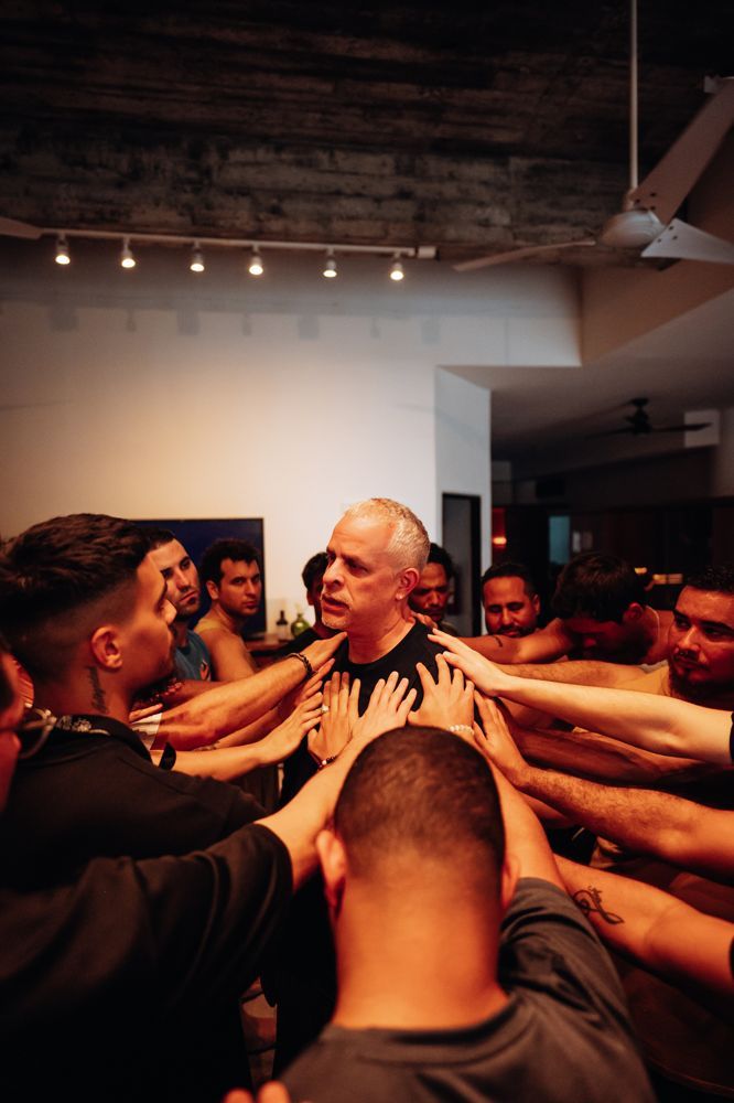 A man held in the circle of brothers